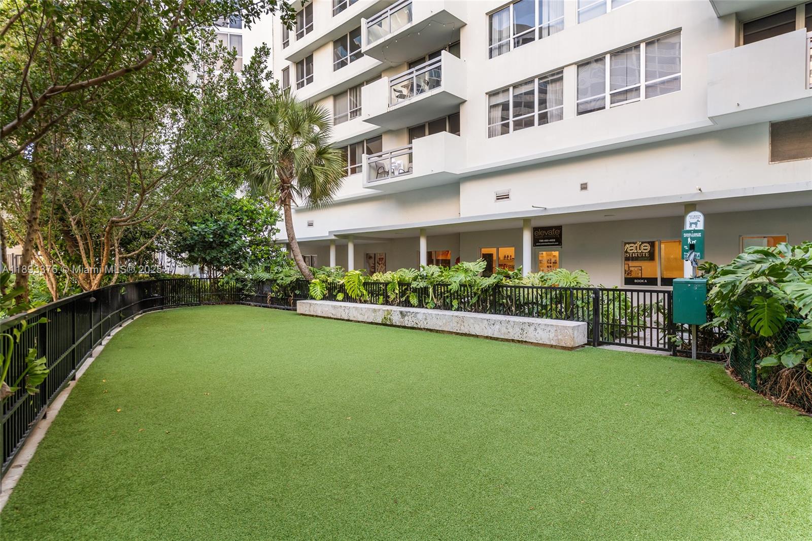 1500 Bay Road, Unit 558S Miami Beach, FL 33139 - Photo 2 of 18 a front view of a building with a garden and trees