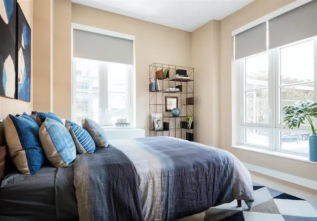 a bedroom with a large bed and a window