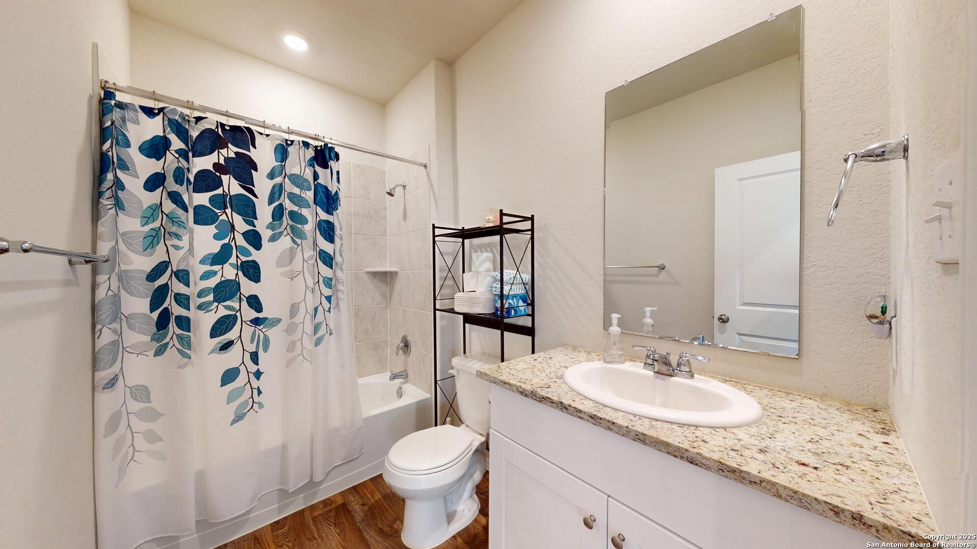 4021 Lilac Path St. Hedwig, TX 78152 - Photo 19 of 49 a bathroom with a granite countertop sink toilet and shower
