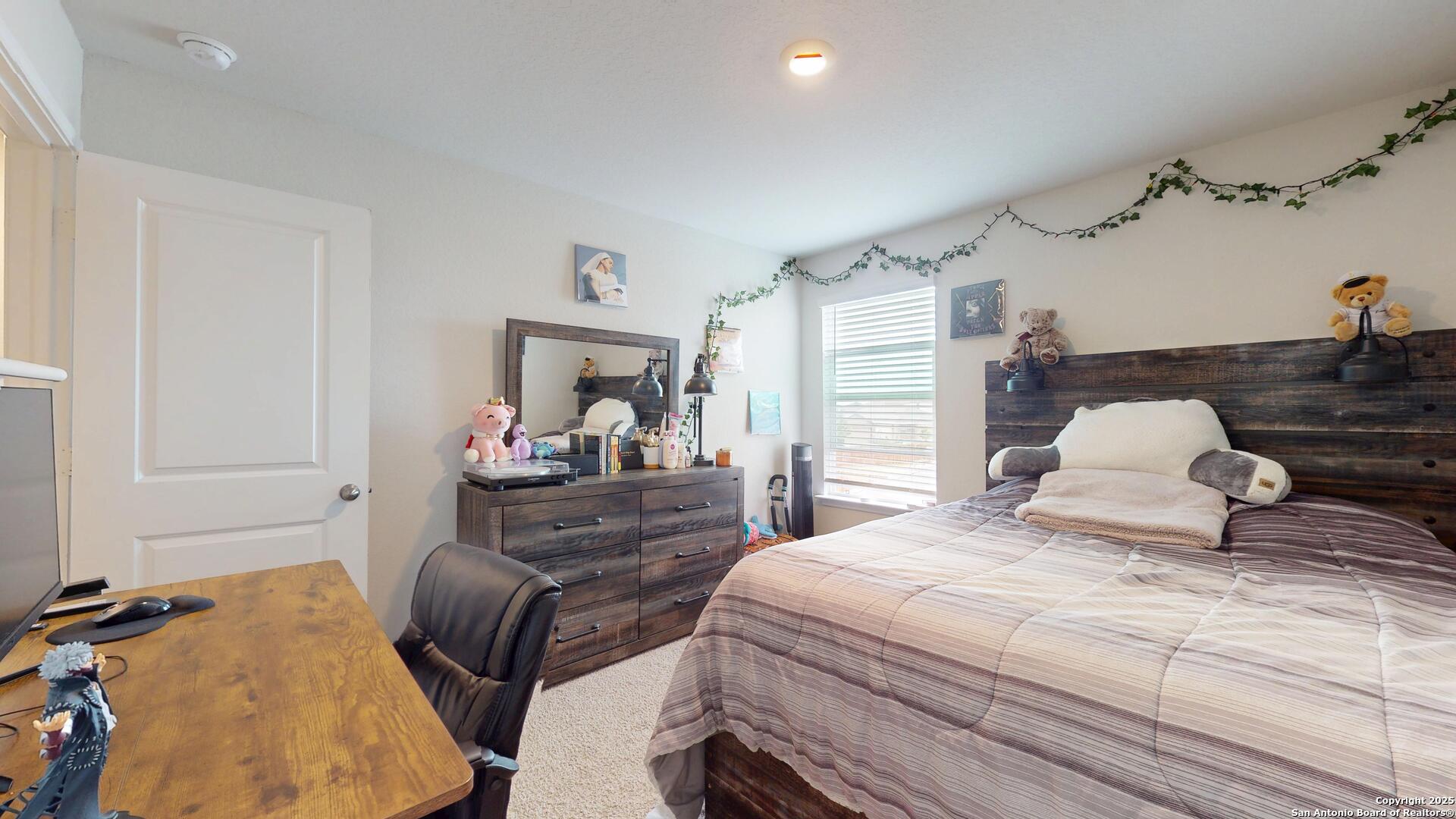 4021 Lilac Path St. Hedwig, TX 78152 - Photo 26 of 49 a bedroom with a bed and wooden floor