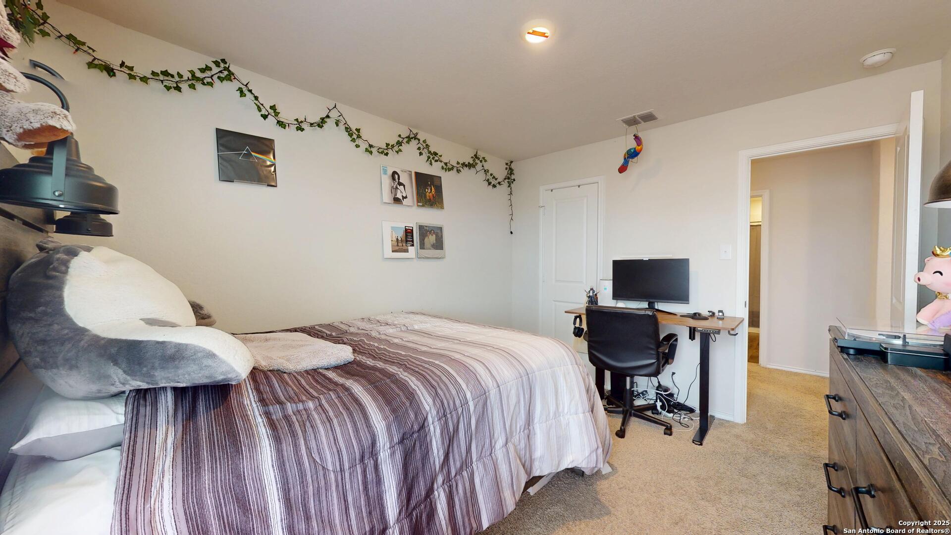 4021 Lilac Path St. Hedwig, TX 78152 - Photo 27 of 49 a bedroom with a bed and a chair