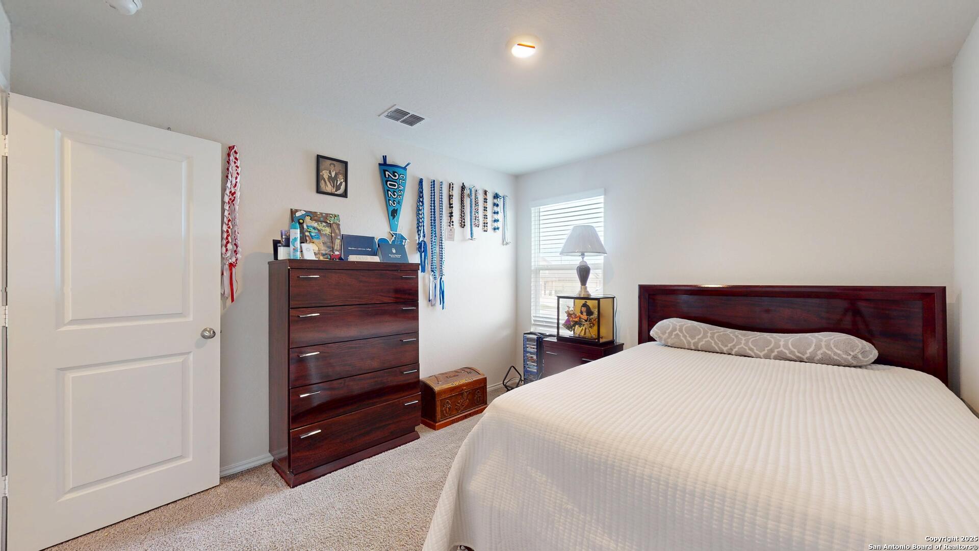 4021 Lilac Path St. Hedwig, TX 78152 - Photo 32 of 49 a bedroom with a bed and a dresser