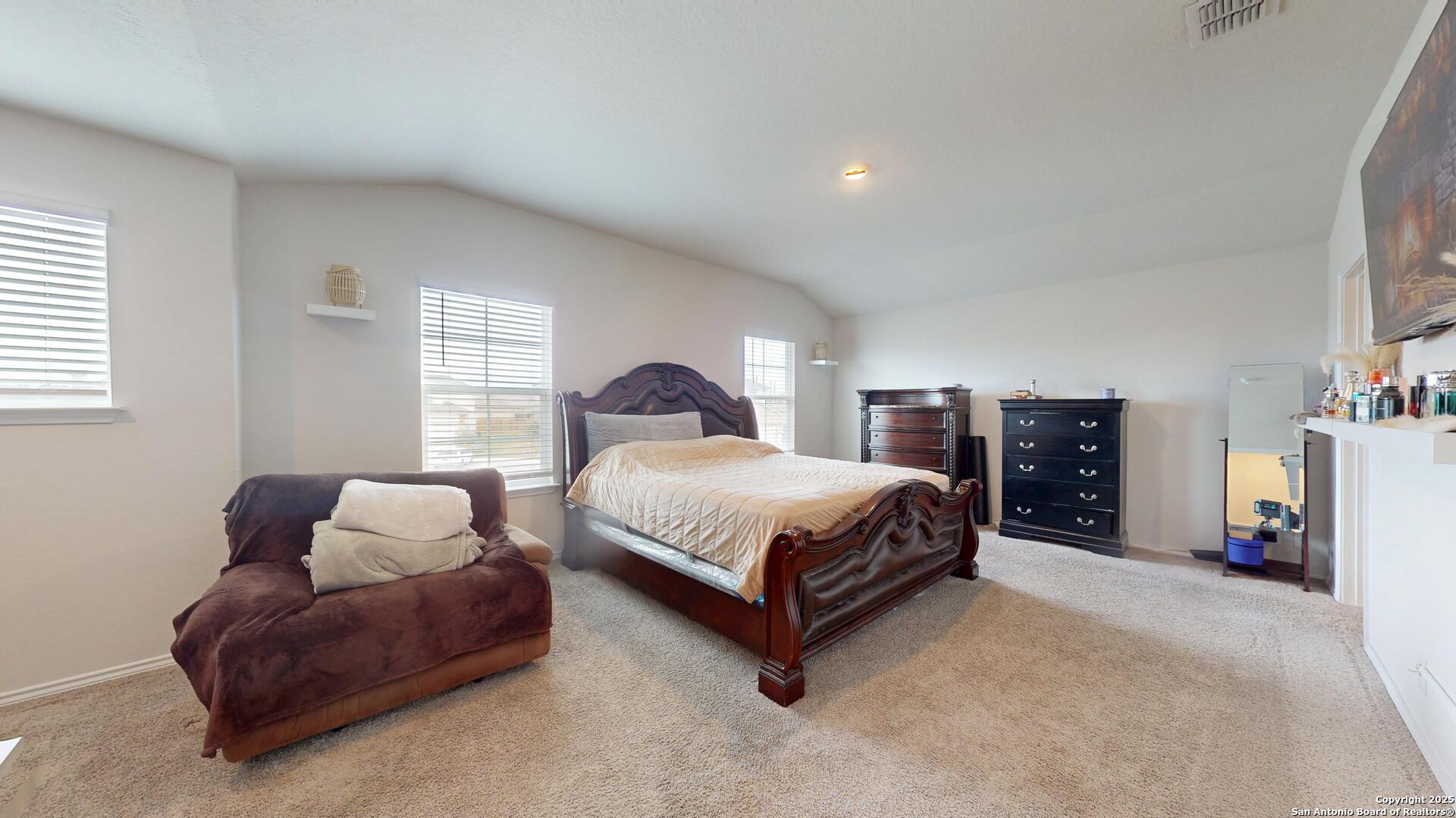 4021 Lilac Path St. Hedwig, TX 78152 - Photo 35 of 49 a spacious bedroom with a bed and a couch