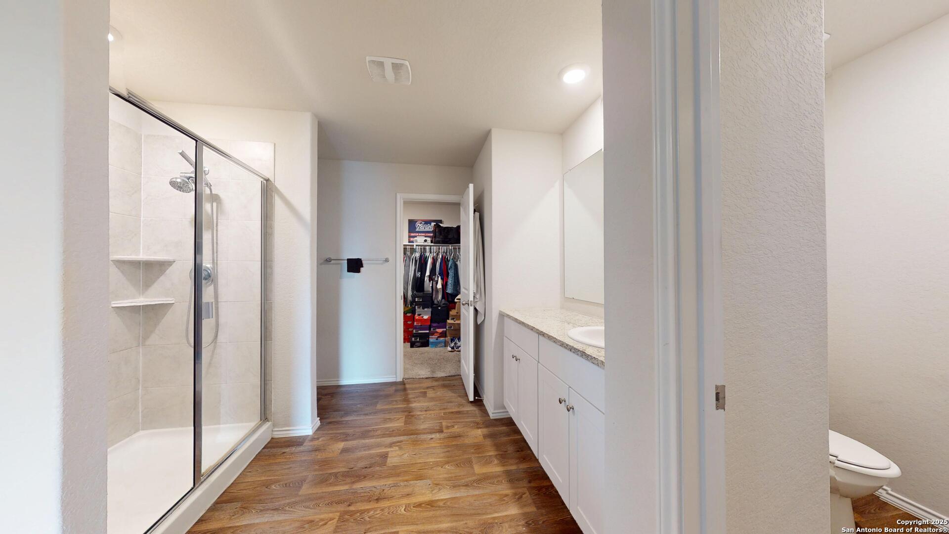 4021 Lilac Path St. Hedwig, TX 78152 - Photo 41 of 49 a view of a hallway with wooden floor and closet