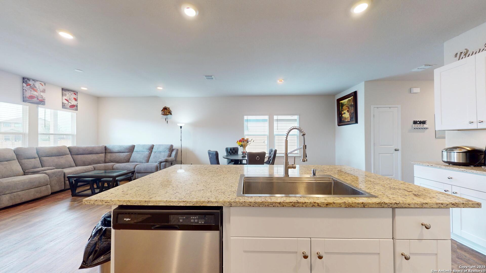 4021 Lilac Path St. Hedwig, TX 78152 - Photo 7 of 49 a kitchen with granite countertop a stove and white cabinets