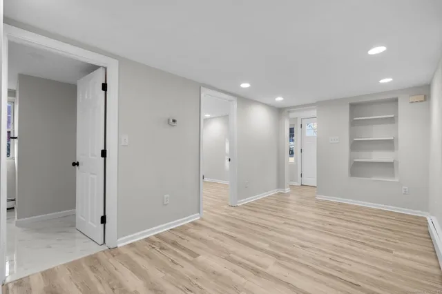 a kitchen with stainless steel appliances a refrigerator sink and white cabinets