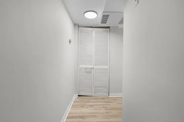 a bathroom with a granite countertop shower and a sink