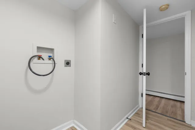 a bathroom with a granite countertop shower and a mirror