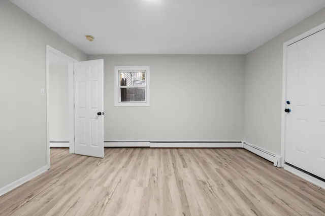 a bathroom with a toilet a sink a mirror and bathtub