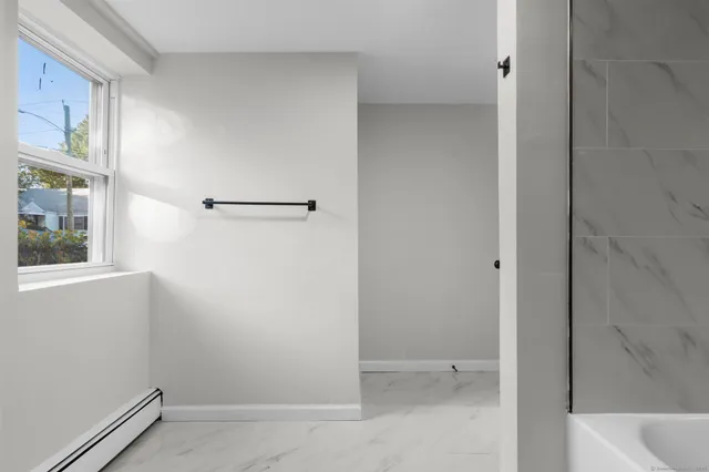 a bathroom with a bathtub and a shower