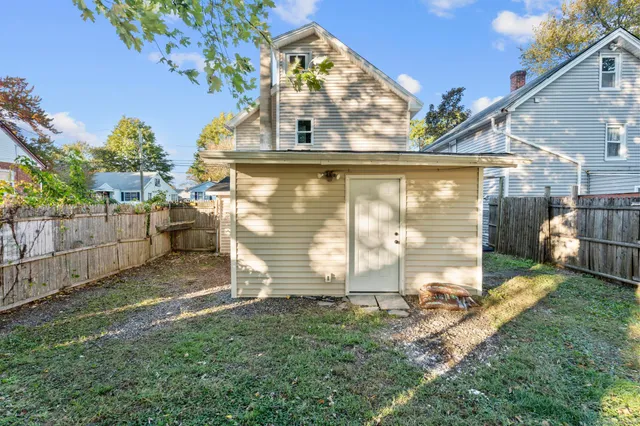 a view of a street with wooden fence