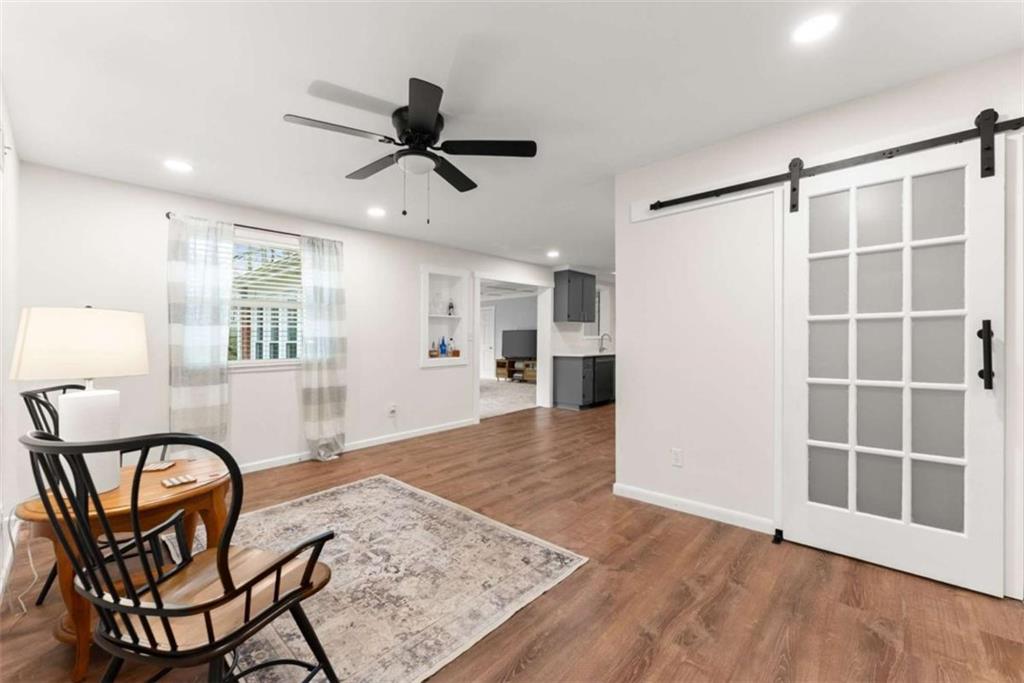 114 Duke Street Jefferson, GA 30549 - Photo 14 of 46 a view of a livingroom with furniture a ceiling fan and windows