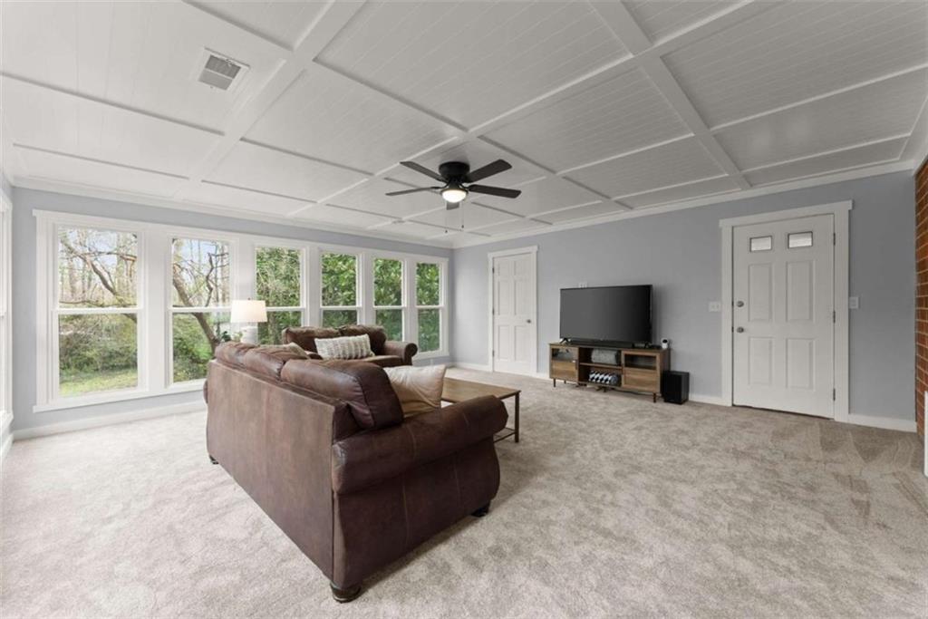 114 Duke Street Jefferson, GA 30549 - Photo 19 of 46 a living room with furniture and a flat screen tv