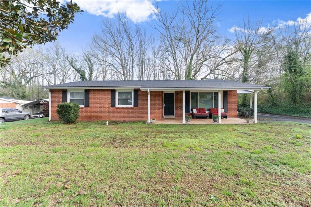 114 Duke Street Jefferson, GA 30549 - Photo 2 of 46 a front view of a house with a garden