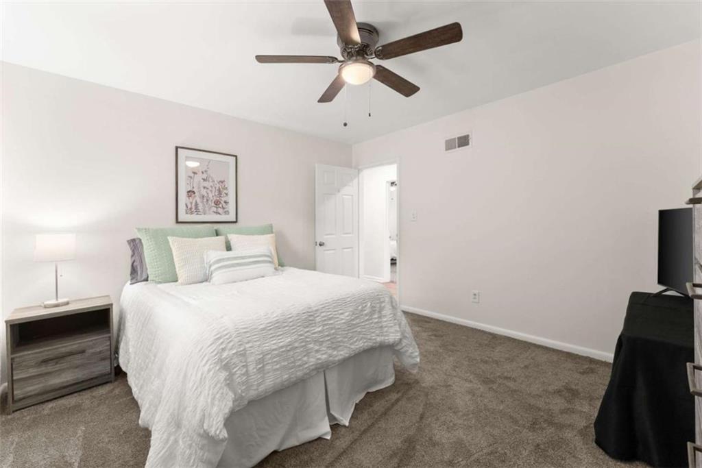 114 Duke Street Jefferson, GA 30549 - Photo 22 of 46 a bedroom with a bed and a flat screen tv