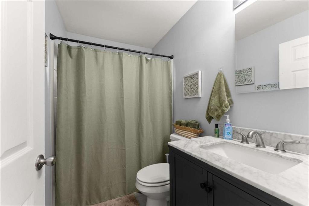 114 Duke Street Jefferson, GA 30549 - Photo 24 of 46 a bathroom with a granite countertop sink toilet and a mirror