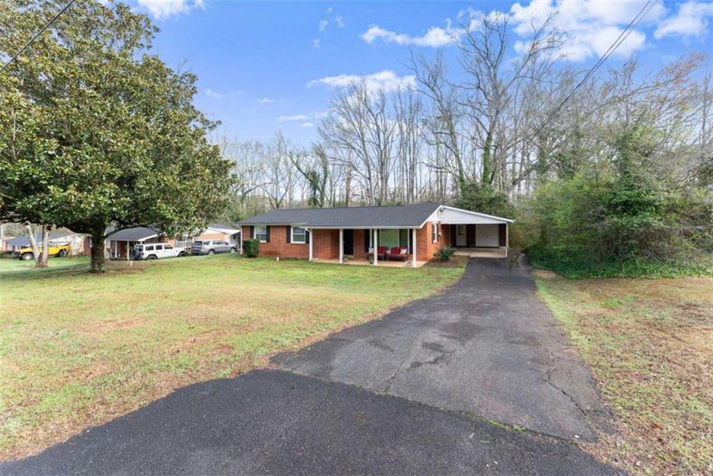 114 Duke Street Jefferson, GA 30549 - Photo 5 of 46 a front view of a house with a yard and trees