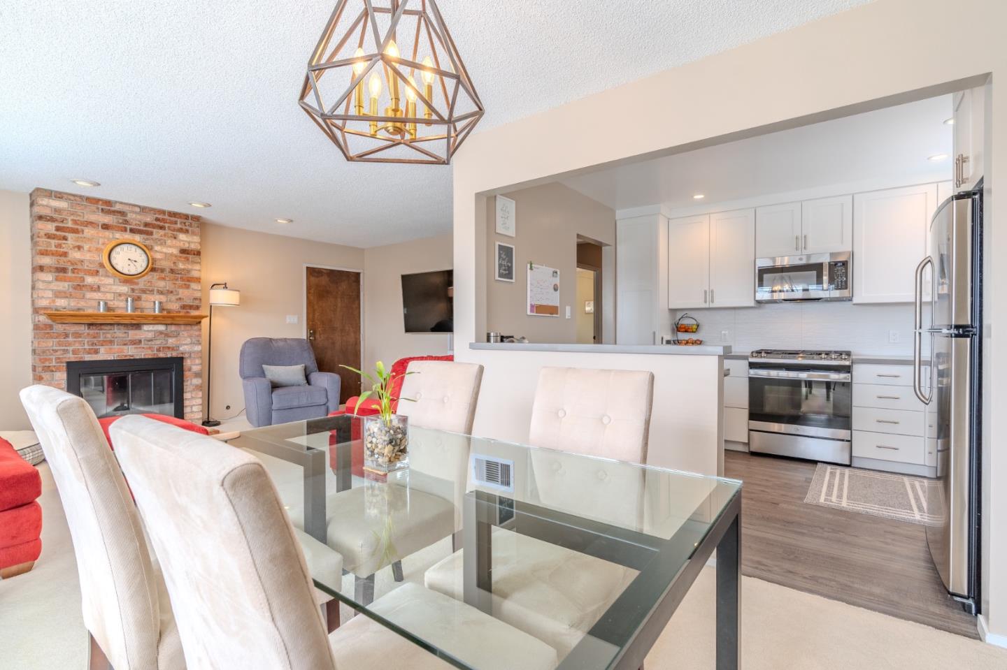 42 Eastridge Circle Pacifica, CA 94044 - Photo 11 of 33 a living room with fireplace furniture and a kitchen view