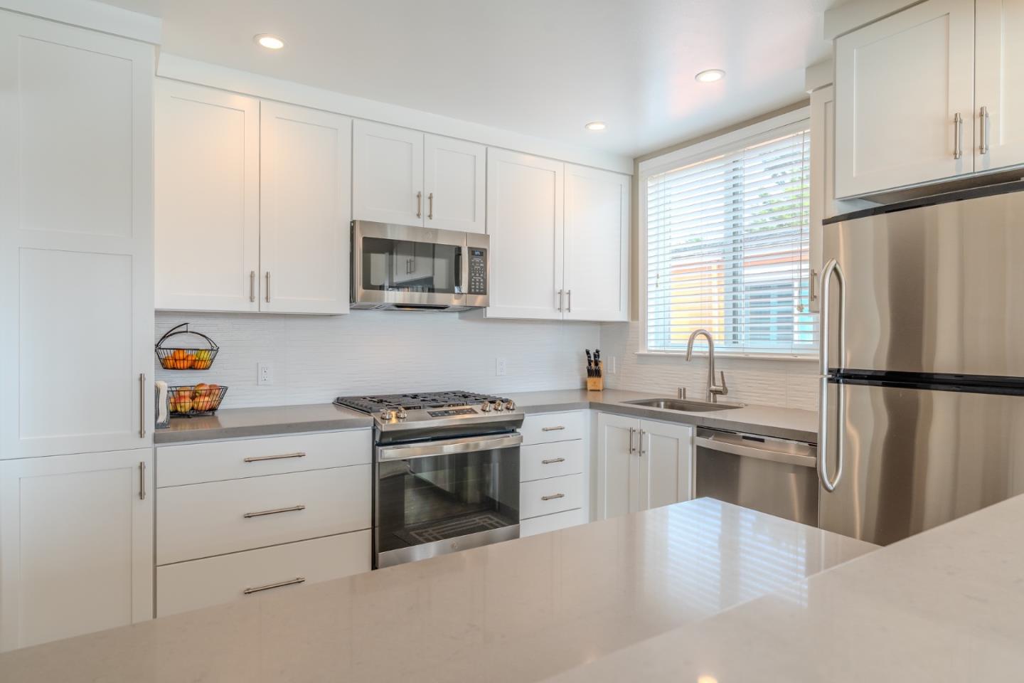 42 Eastridge Circle Pacifica, CA 94044 - Photo 14 of 33 a kitchen with cabinets stainless steel appliances and a window
