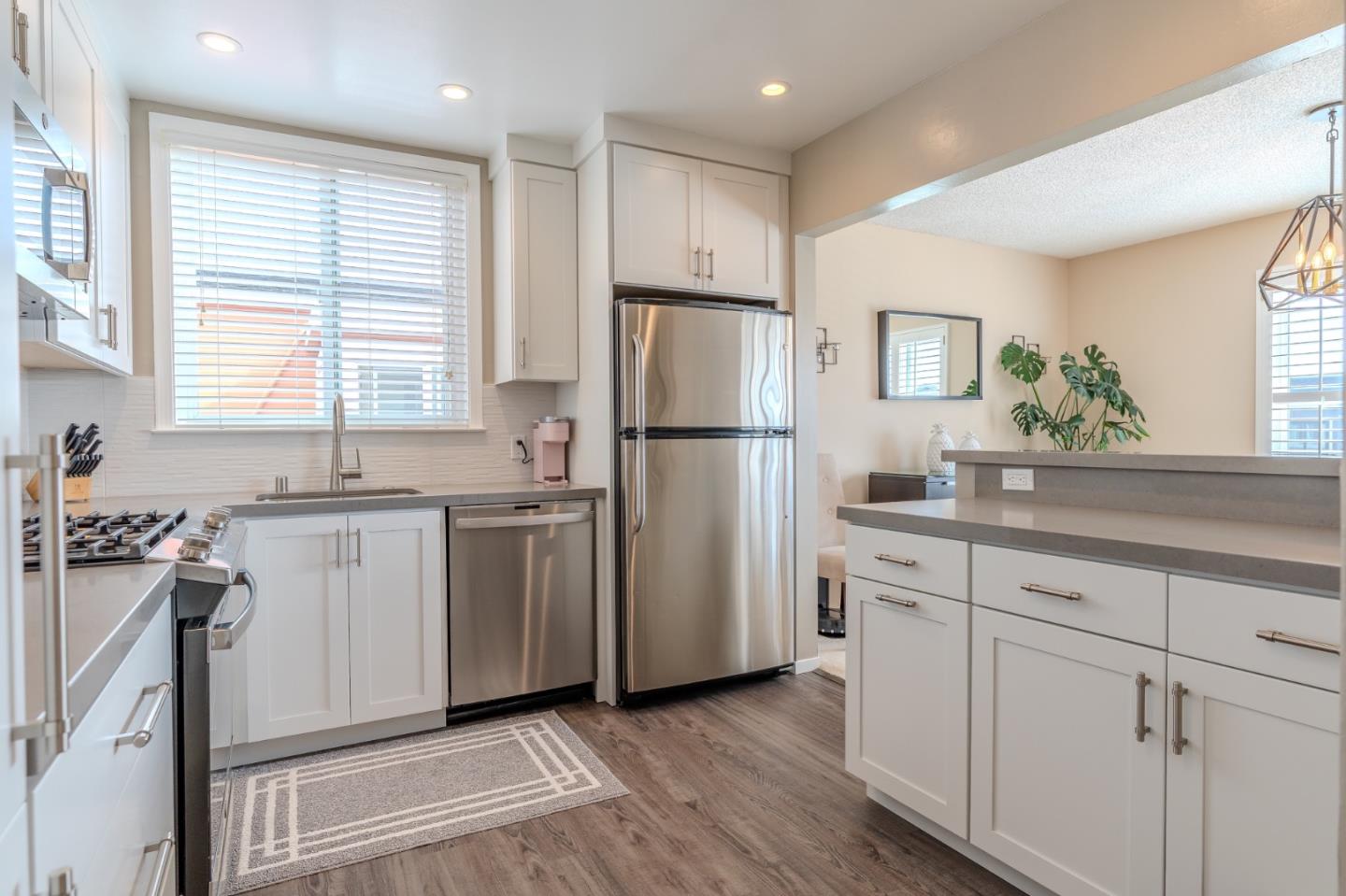42 Eastridge Circle Pacifica, CA 94044 - Photo 16 of 33 a kitchen with white cabinets and white appliances
