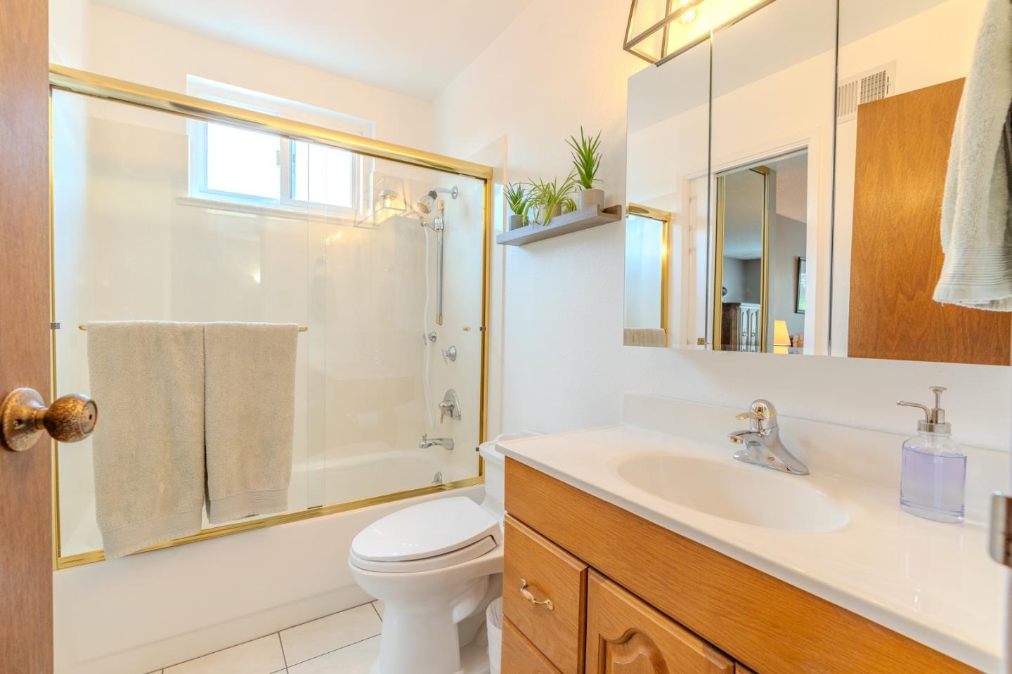 42 Eastridge Circle Pacifica, CA 94044 - Photo 18 of 33 a bathroom with a sink a toilet a mirror and shower