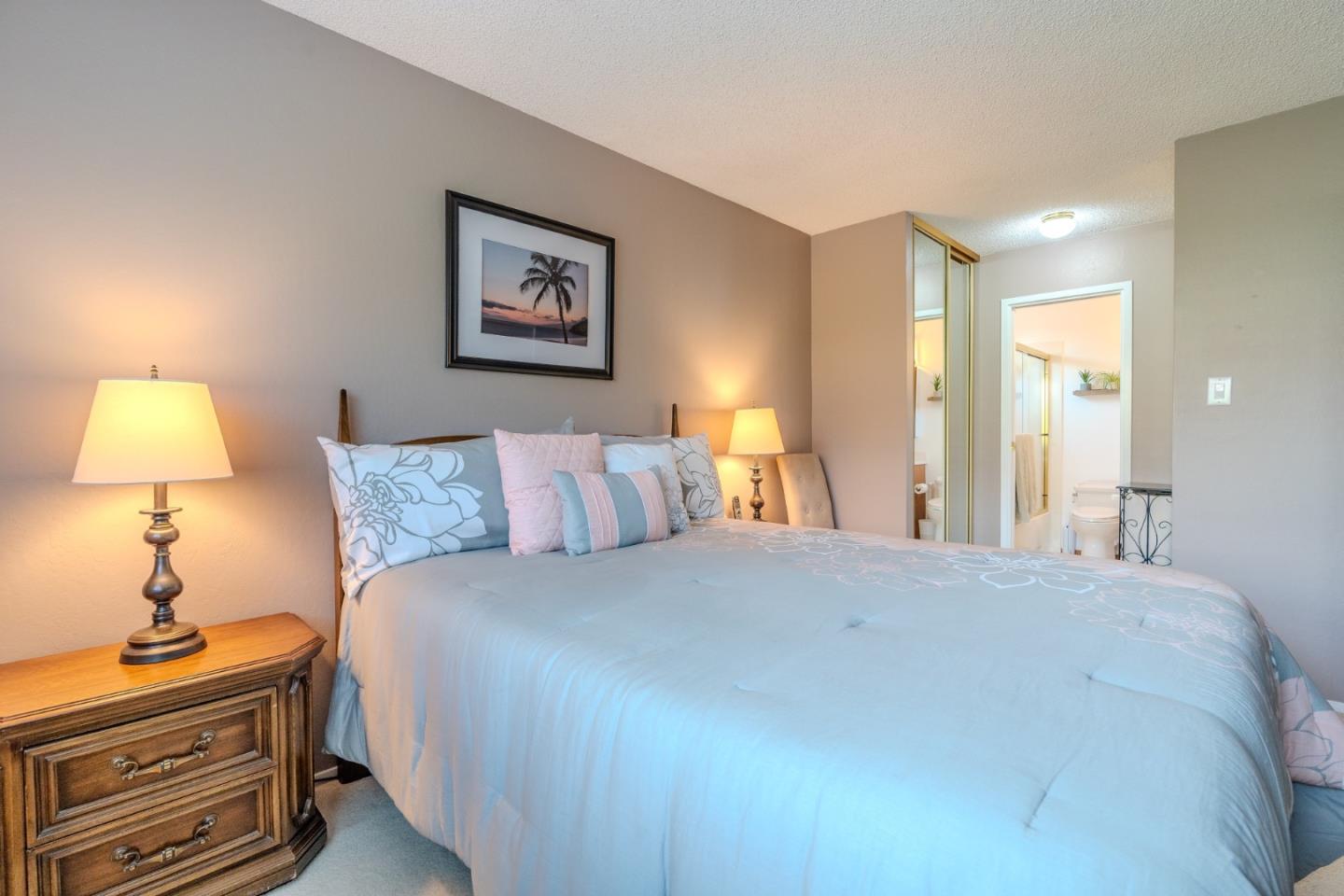 42 Eastridge Circle Pacifica, CA 94044 - Photo 20 of 33 a bedroom with a bed and a lamp on dresser