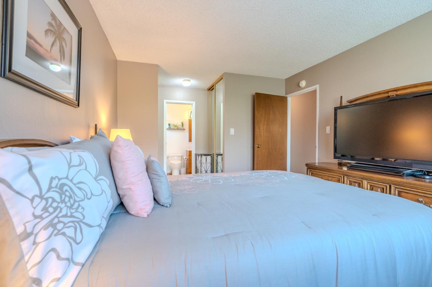 42 Eastridge Circle Pacifica, CA 94044 - Photo 21 of 33 a bedroom with a bed and a flat screen tv