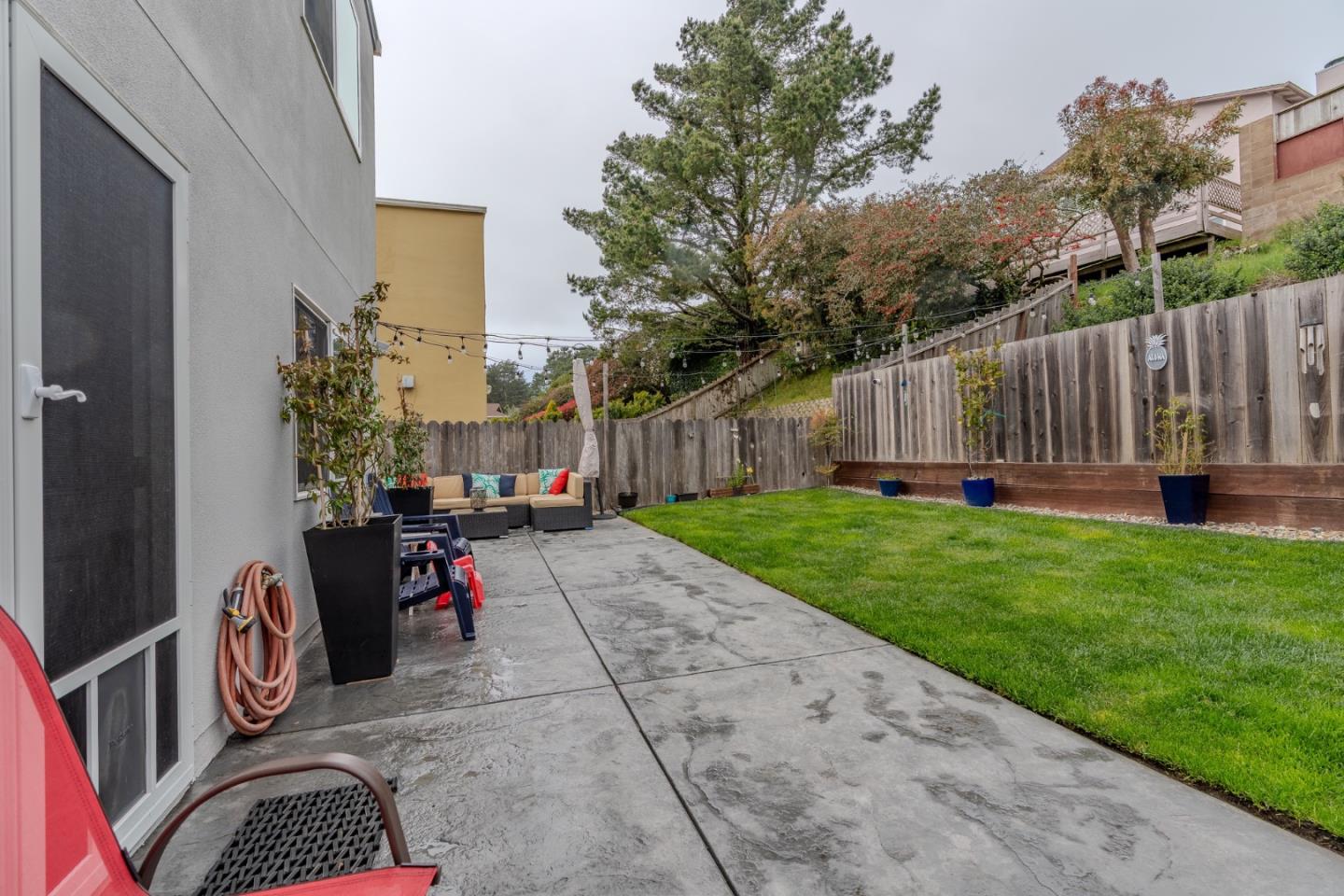 42 Eastridge Circle Pacifica, CA 94044 - Photo 31 of 33 a view of backyard with table and chairs and potted plants