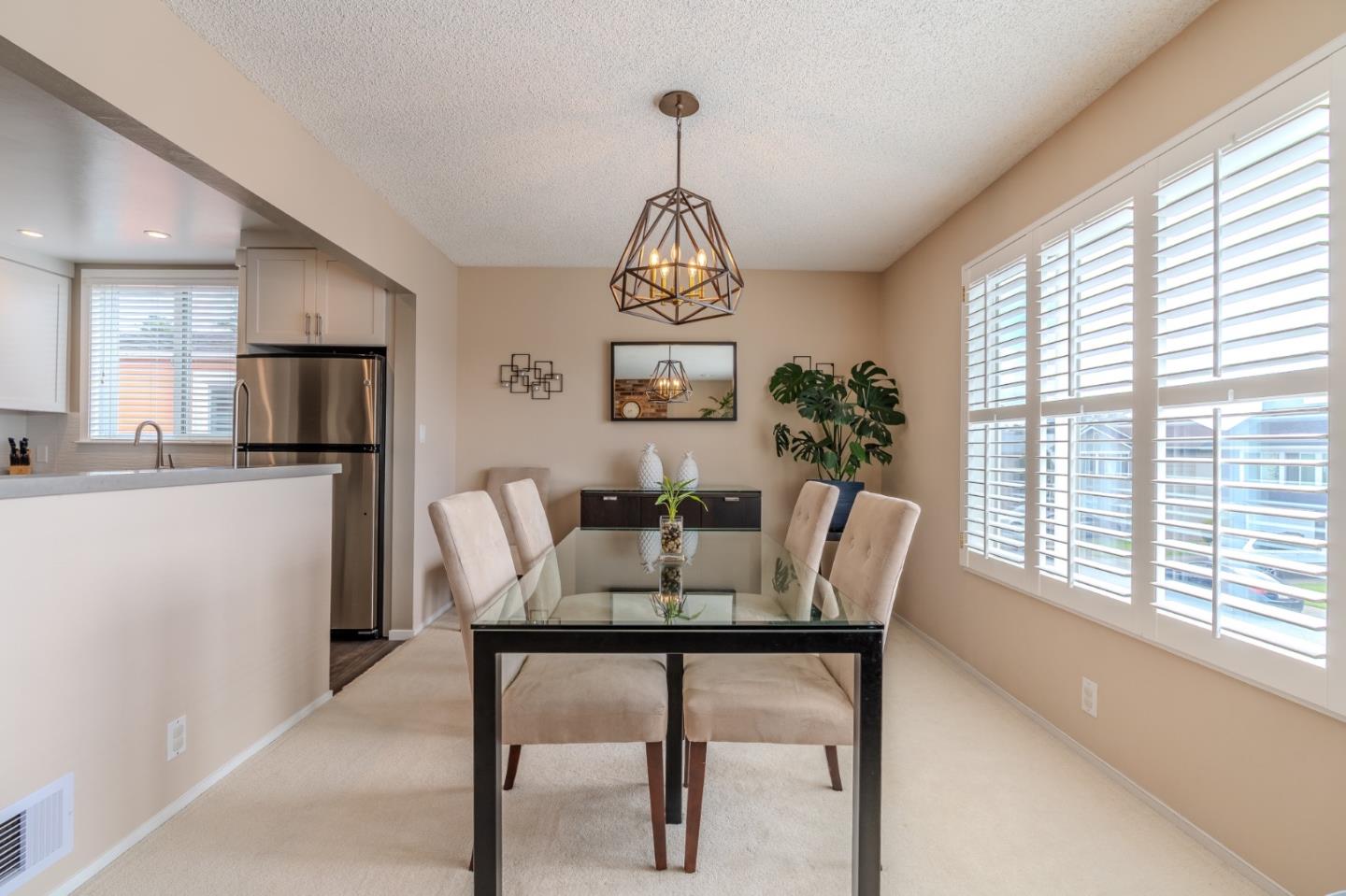 42 Eastridge Circle Pacifica, CA 94044 - Photo 9 of 33 a dining room with furniture a chandelier and window