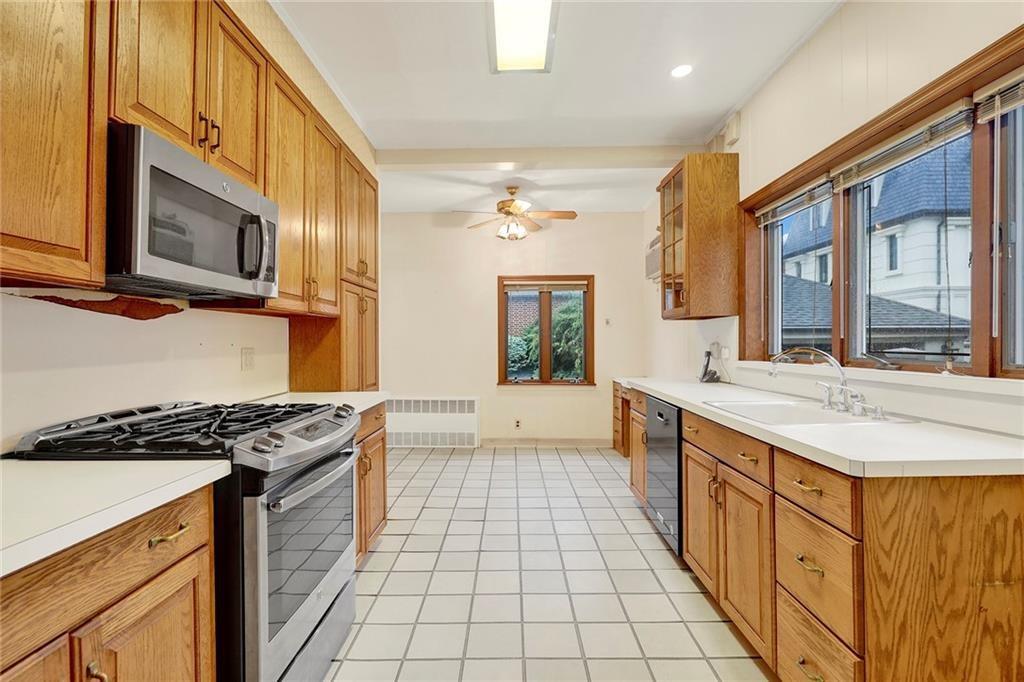 8016 Colonial Road Brooklyn, NY 11209 - Photo 20 of 43 a kitchen with stainless steel appliances granite countertop a stove a sink and a microwave