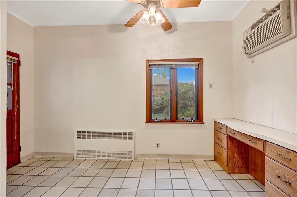 8016 Colonial Road Brooklyn, NY 11209 - Photo 24 of 43 a view of an empty room with window and chandelier fan