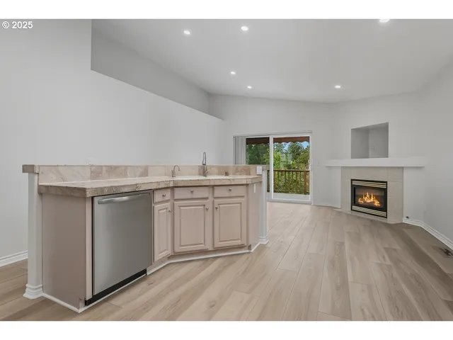 a kitchen with a sink cabinets and wooden floor