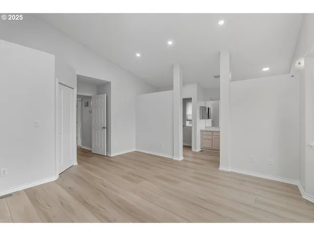a view of an empty room with wooden floor