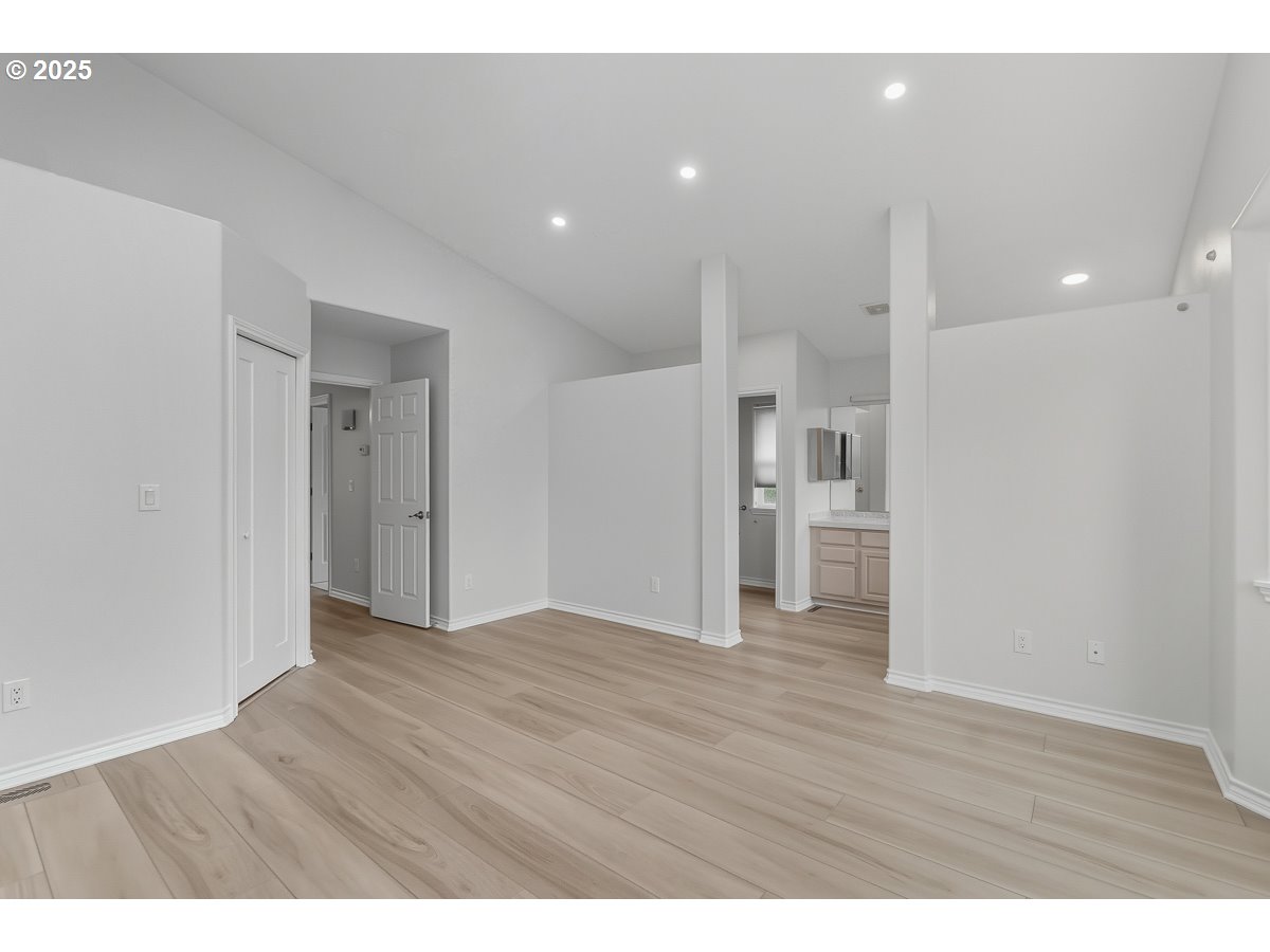 3379 Northwest Banff Drive Portland, OR 97229 - Photo 14 of 26 a view of an empty room with wooden floor