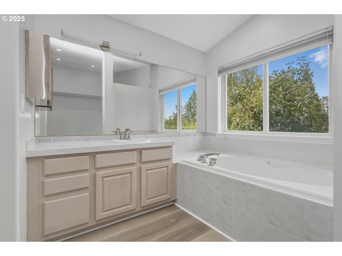 3379 Northwest Banff Drive Portland, OR 97229 - Photo 16 of 26 a spacious bathroom with a tub sink and mirror