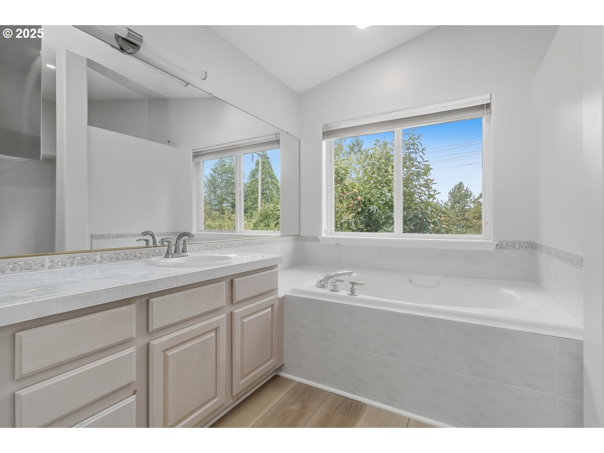 3379 Northwest Banff Drive Portland, OR 97229 - Photo 17 of 26 a bathroom with a tub a sink and a window