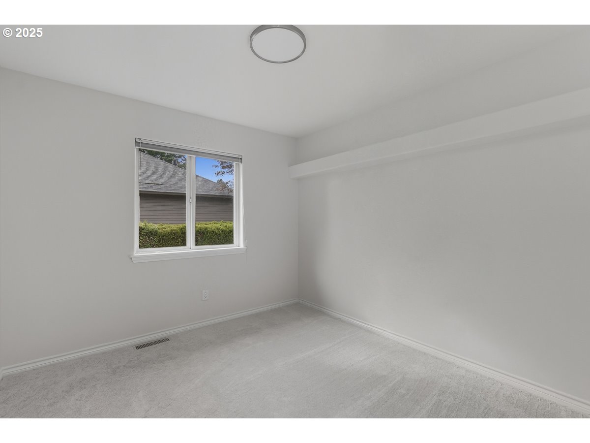 3379 Northwest Banff Drive Portland, OR 97229 - Photo 22 of 26 a view of an empty room with a window