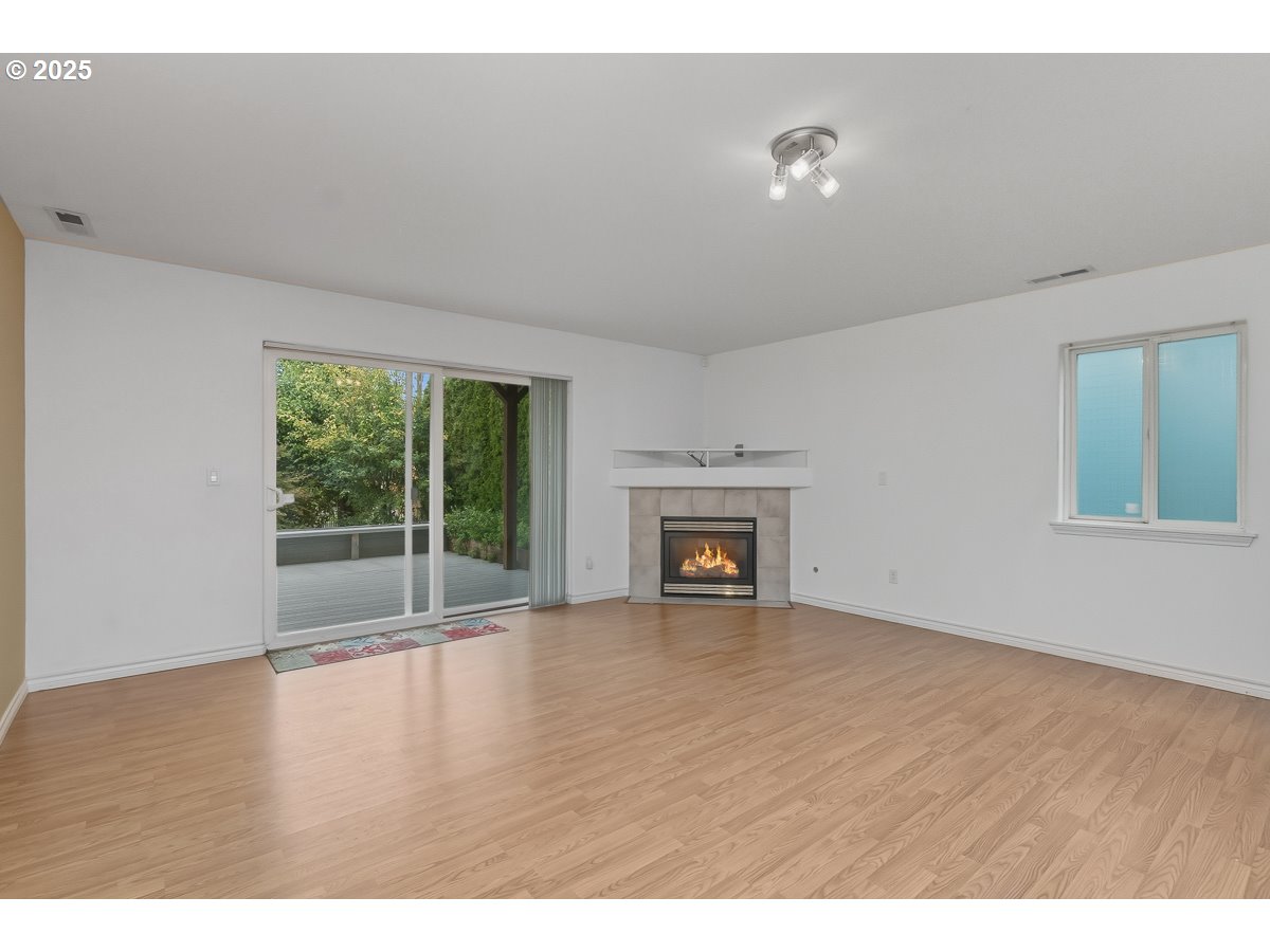 3379 Northwest Banff Drive Portland, OR 97229 - Photo 24 of 26 a view of an empty room with wooden floor and a window