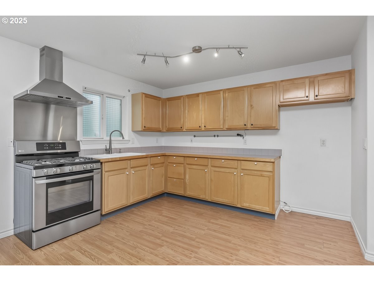 3379 Northwest Banff Drive Portland, OR 97229 - Photo 26 of 26 a kitchen with granite countertop a stove a sink dishwasher and a refrigerator