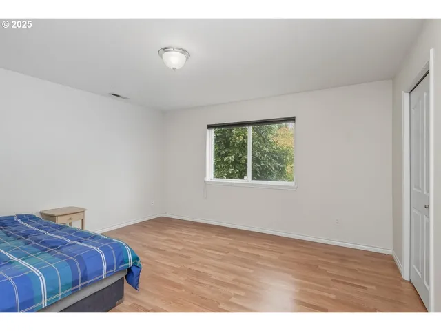 a bedroom with a bed and cabinet