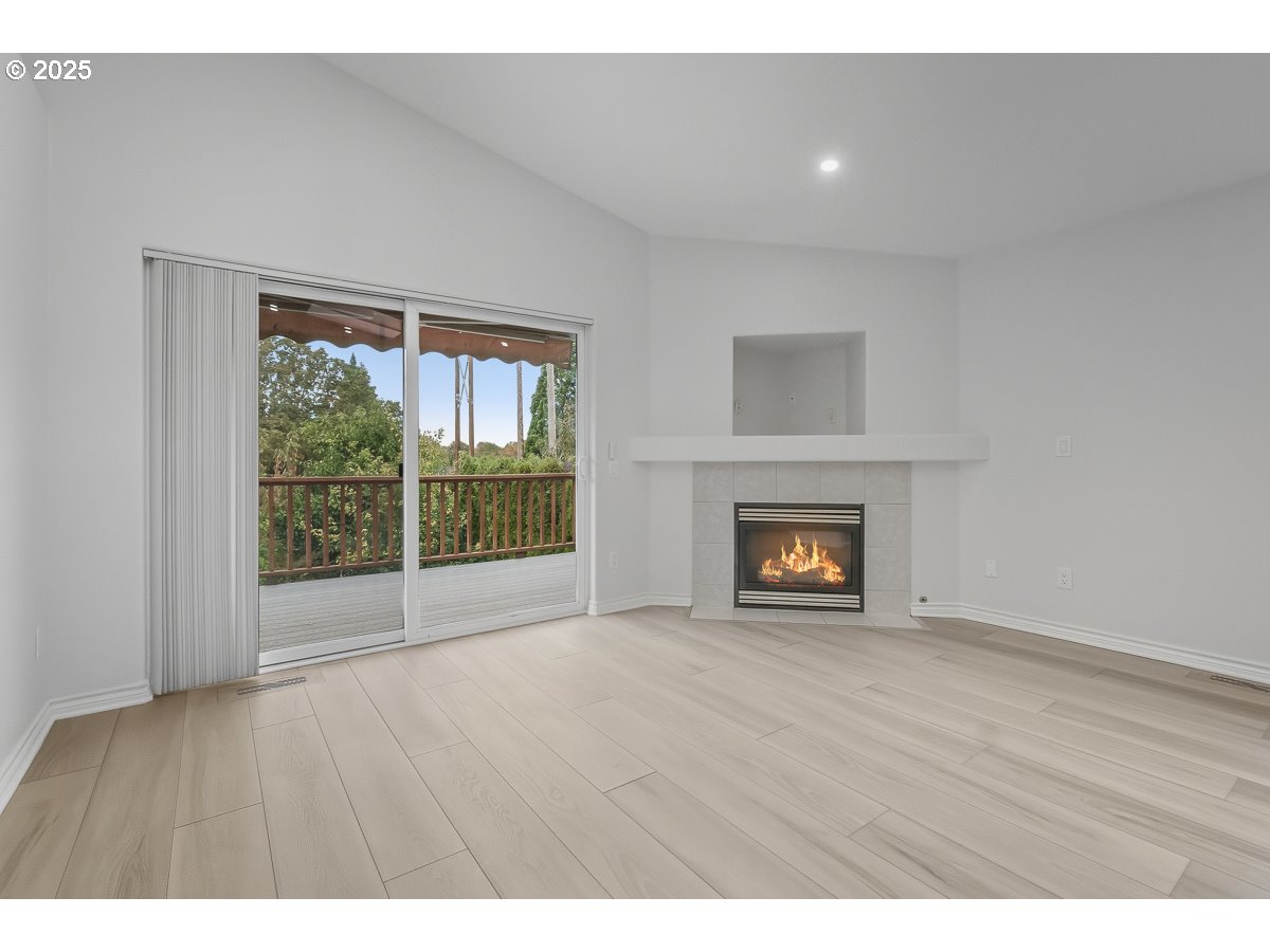 3379 Northwest Banff Drive Portland, OR 97229 - Photo 8 of 26 a view of an empty room with wooden floor and a window