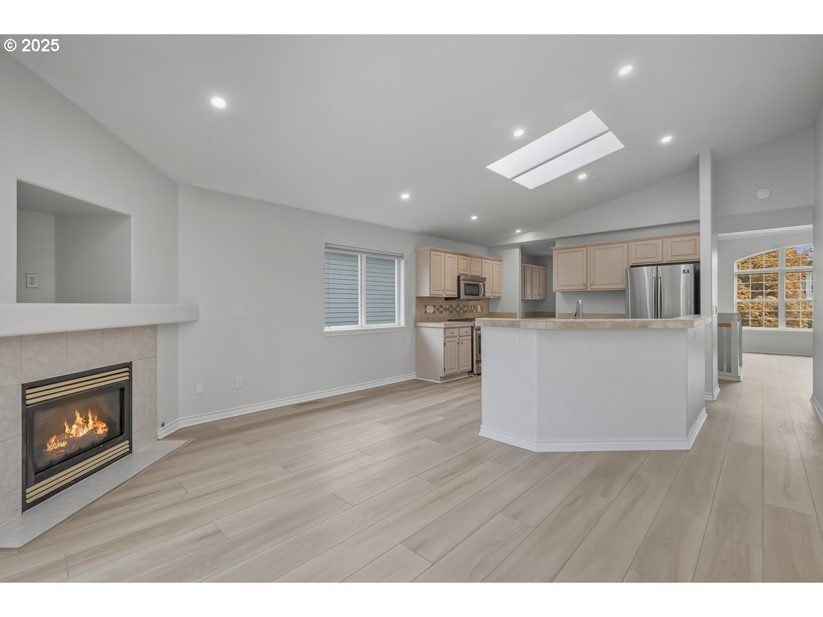 3379 Northwest Banff Drive Portland, OR 97229 - Photo 9 of 26 a living room with a fireplace and wooden floor