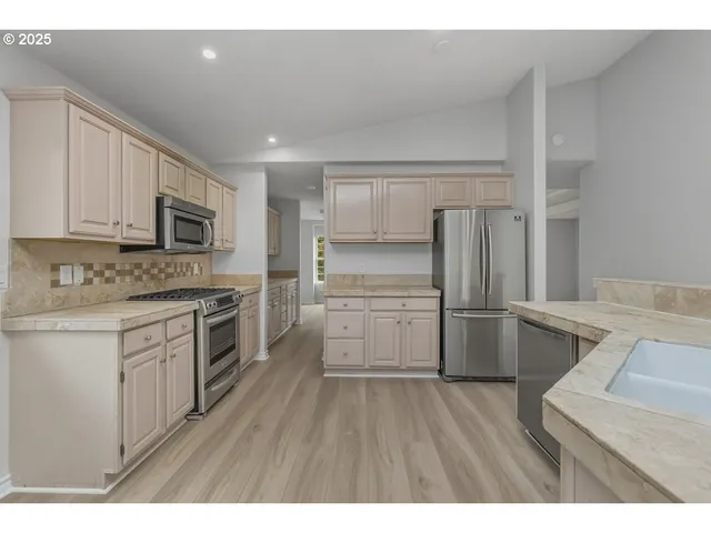 a kitchen with a refrigerator stove and sink