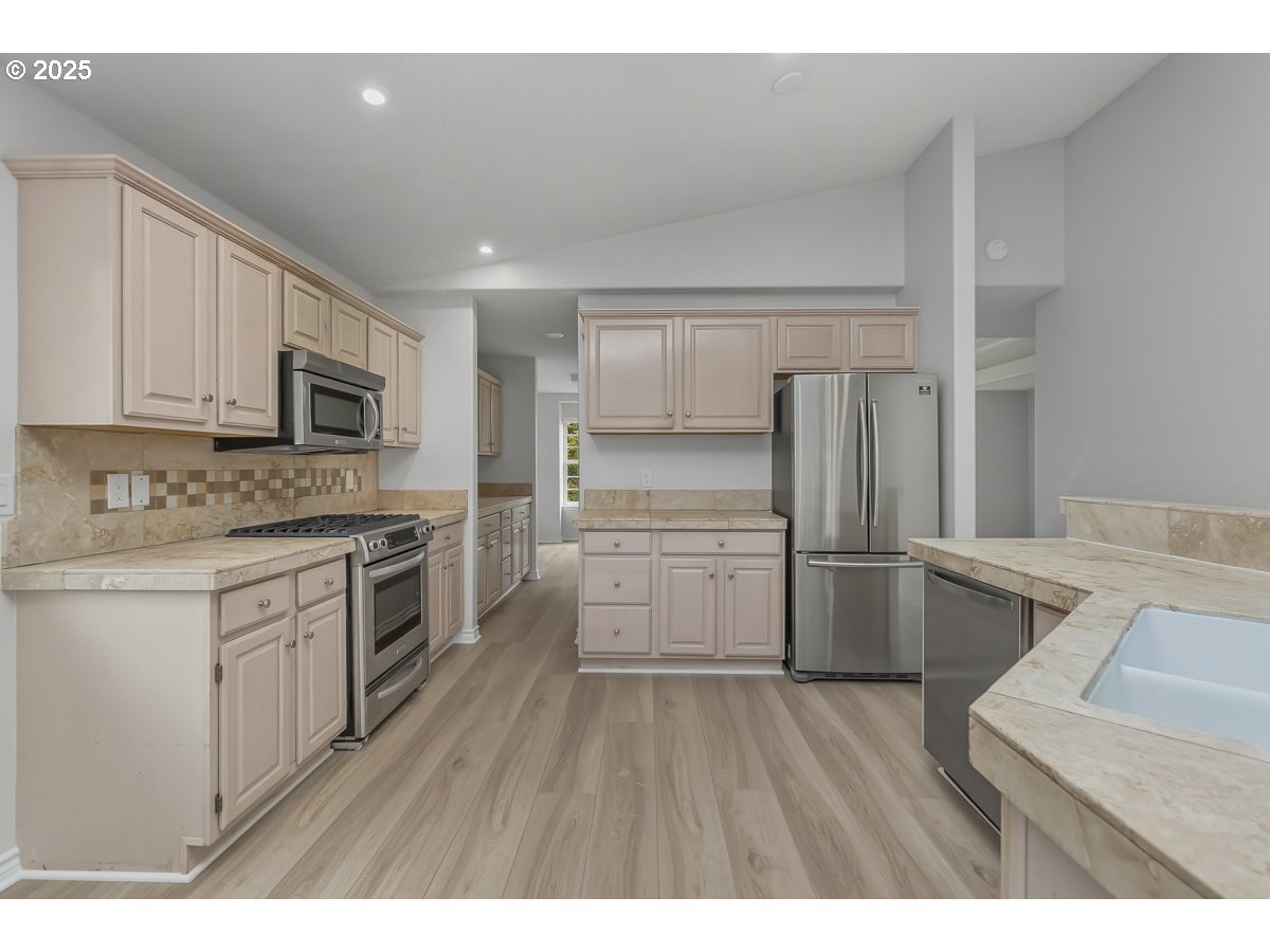 3379 Northwest Banff Drive Portland, OR 97229 - Photo 10 of 26 a kitchen with a refrigerator stove and sink