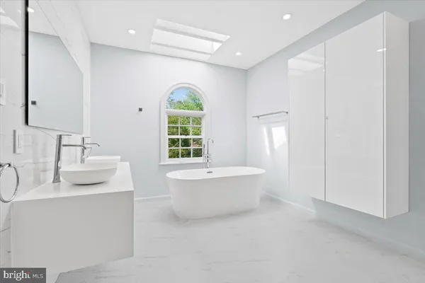 a bathroom with a sink toilet and tub