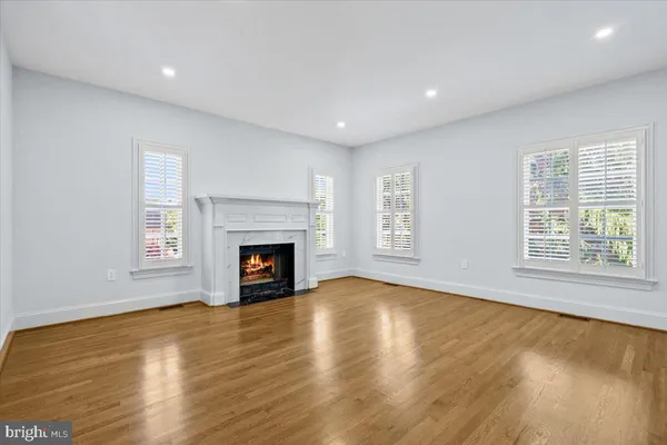 a view of an empty room with a fireplace and a window