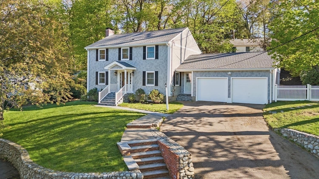 a front view of a house with a garden
