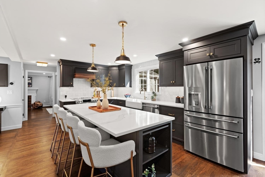 5 Alpine Circle Wakefield, MA 01880 - Photo 15 of 42 a kitchen with stainless steel appliances a dining table chairs and wooden floor
