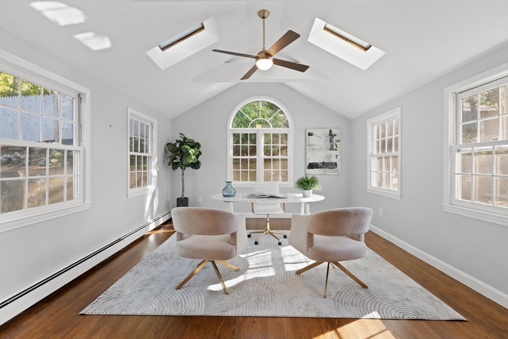 5 Alpine Circle Wakefield, MA 01880 - Photo 25 of 42 a dining room with wooden floor a chandelier fan a wooden table and chairs