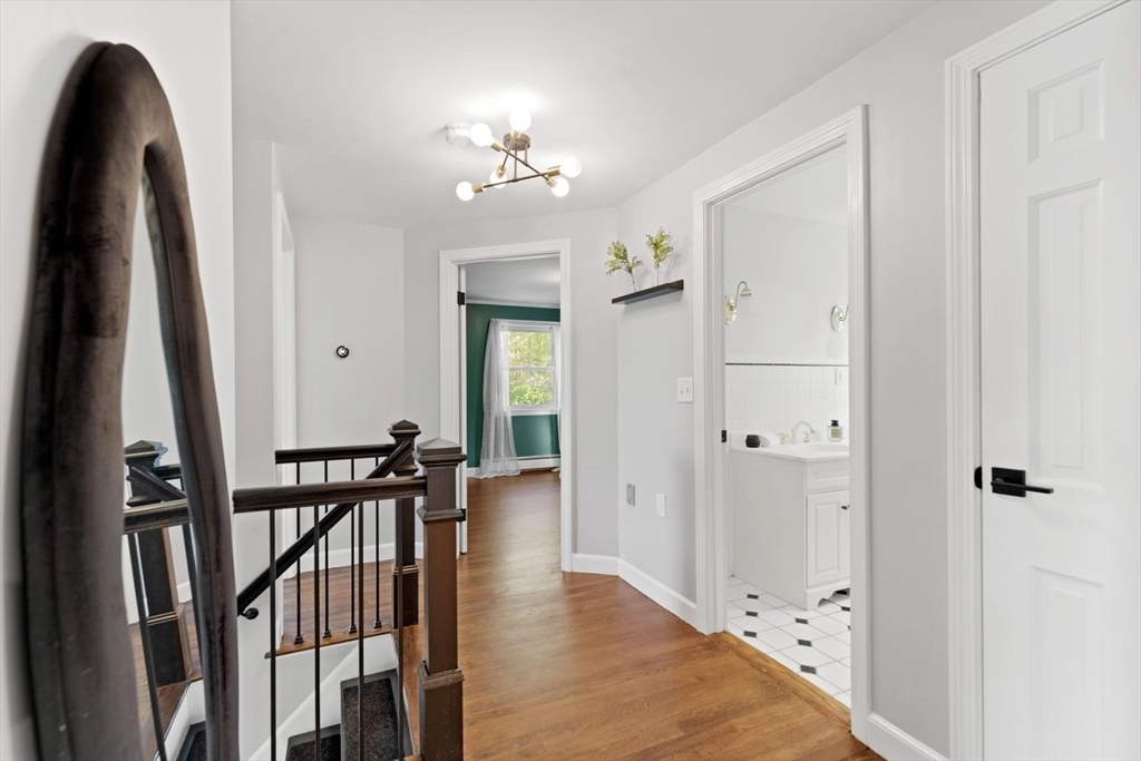 5 Alpine Circle Wakefield, MA 01880 - Photo 29 of 42 a view of a hallway with wooden floor and staircase